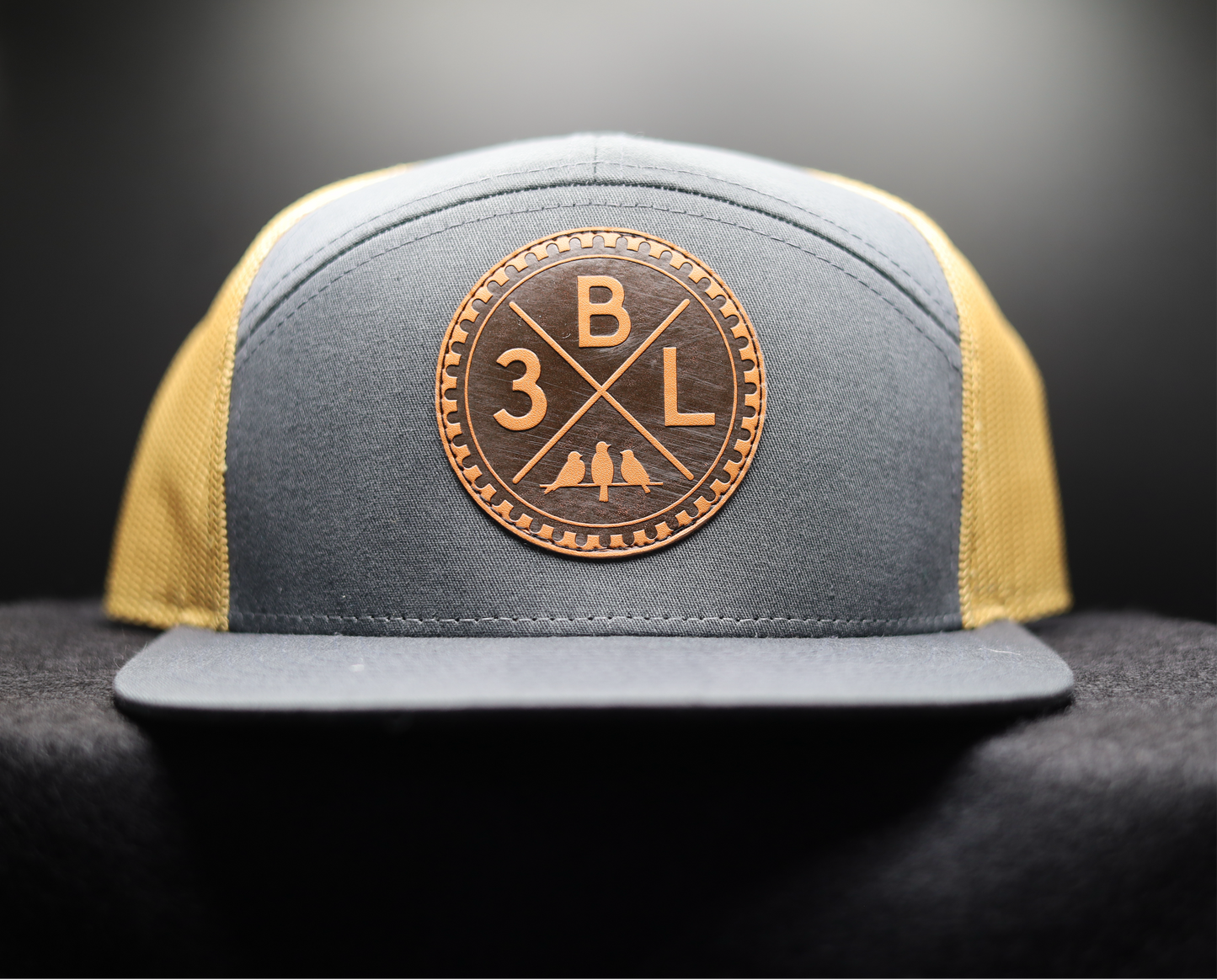 3 Bird Lifestyle Seven-Panel Trucker •Charcoal & Old Gold• 3BXL Leather Patch