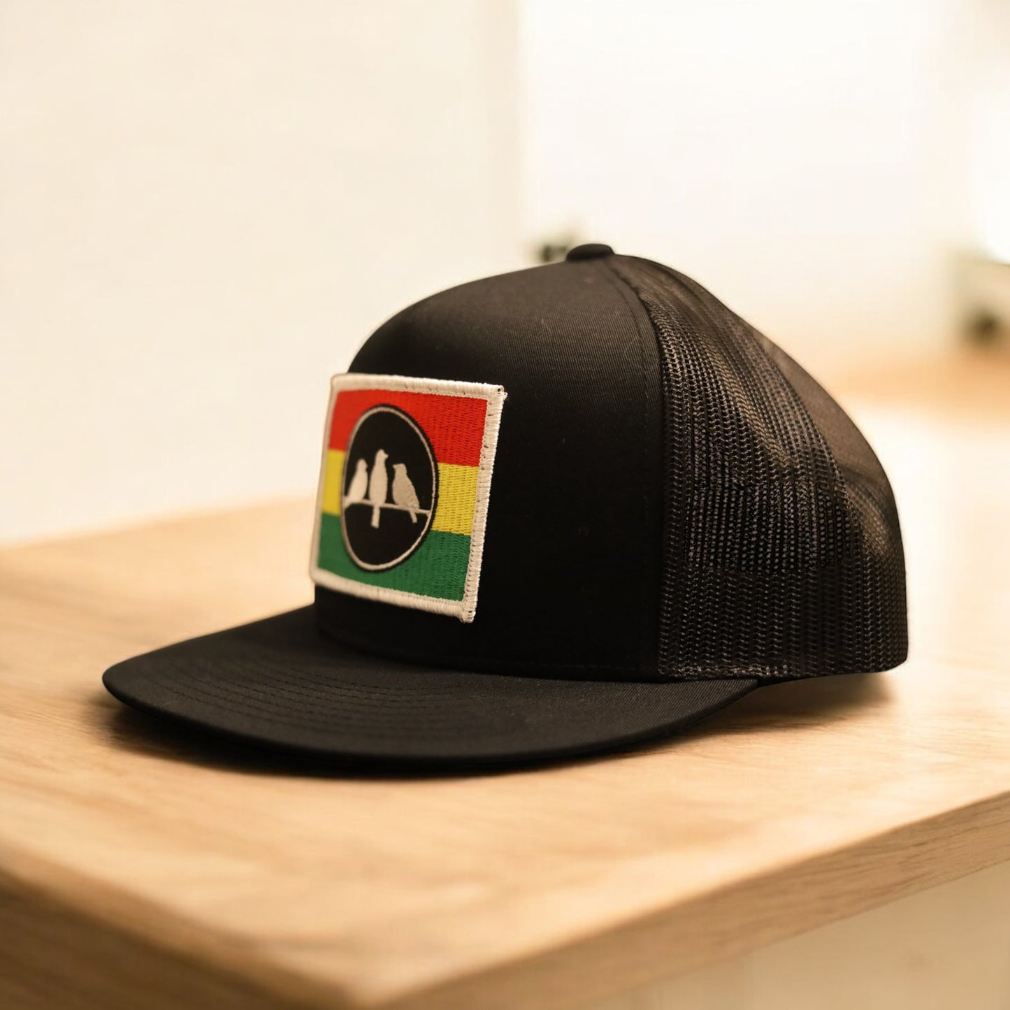 3 Bird Lifestyle Flat Bill Trucker
 • Black and Black • 3 Bird Rasta Flag Patch