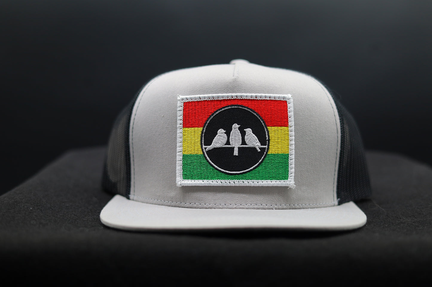 3 Bird Lifestyle Flat Bill Trucker
 •Silver & Black • 3 Bird Rasta Flag Patch