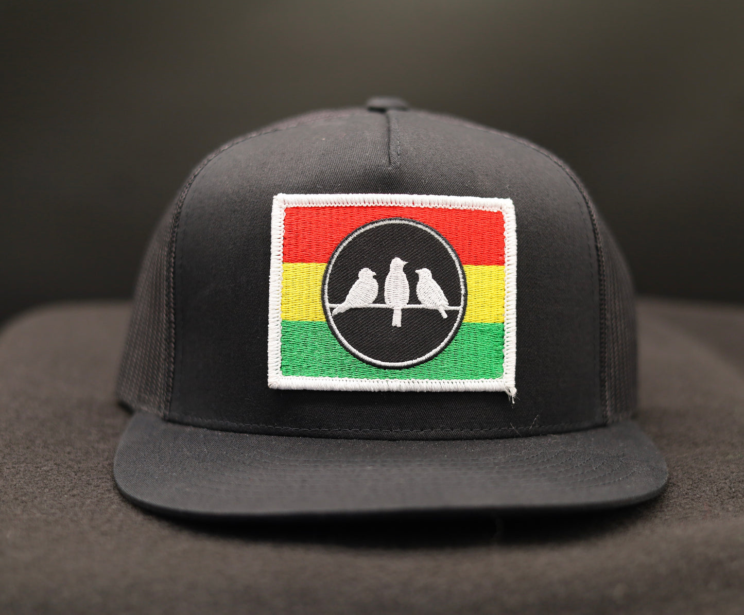 Old School Flat Bill Trucker • Black and Black • 3 Bird Rasta Flag Patch