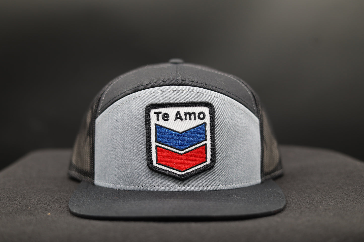 3 Bird Lifestyle Seven-Panel Trucker 
 • Heather Grey & Black• Te Amo Patch